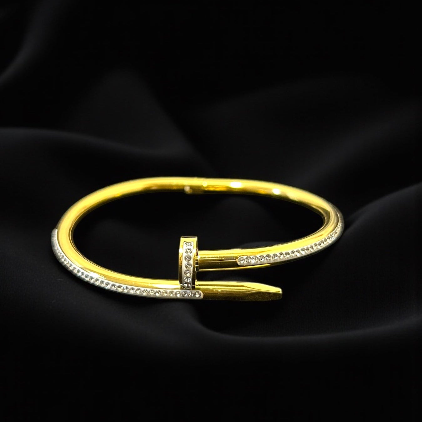 Gold anti tarnish bracelet with a unique design on a black background