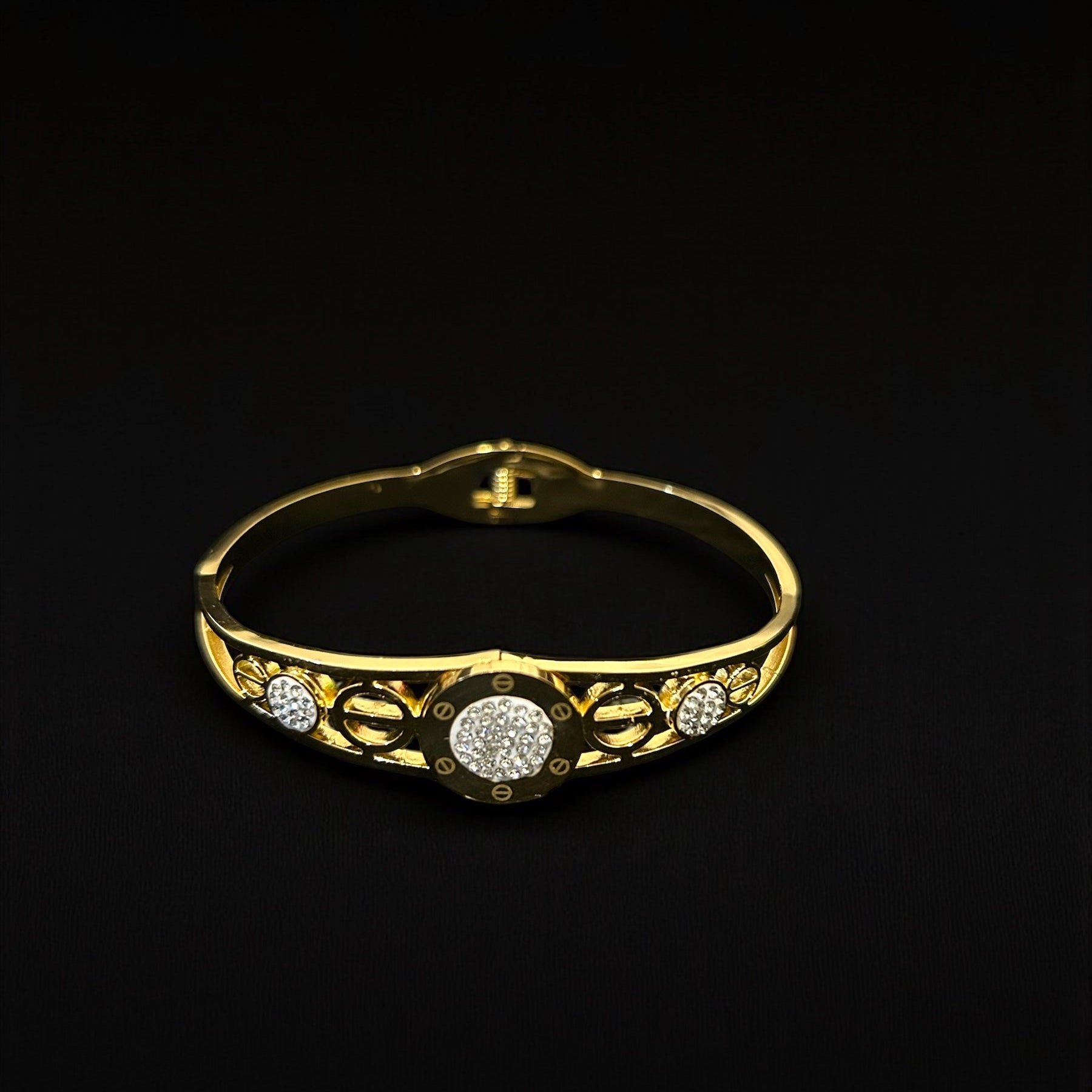 anti tarnish Gold colour bracelet with diamond accents on a black background