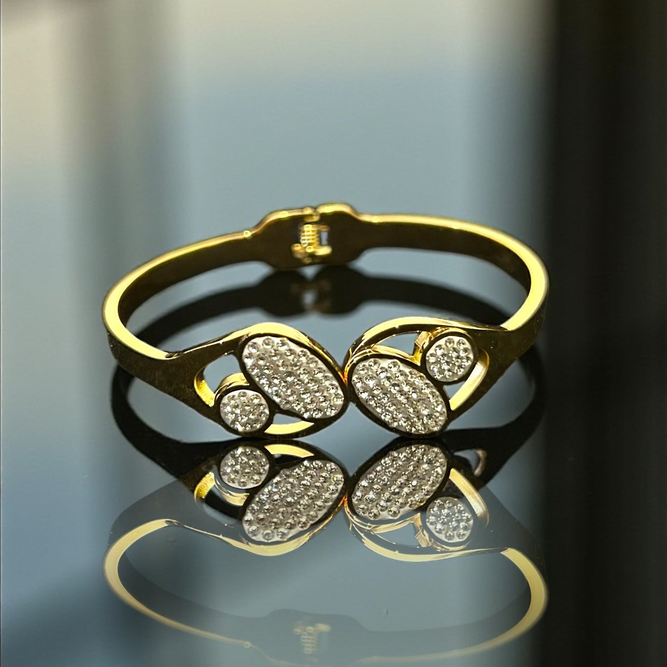Anti tarnish Gold colour  bracelet with diamond accents on a reflective surface