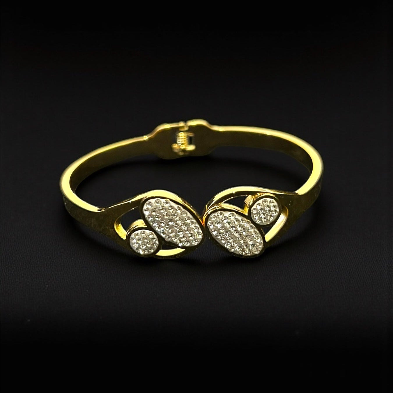 Anti tarnish Gold colour bracelet with paw print design on a black background