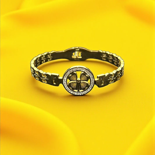 Anti tarnish Gold Colour Bracelet with a central circular design on a yellow fabric background