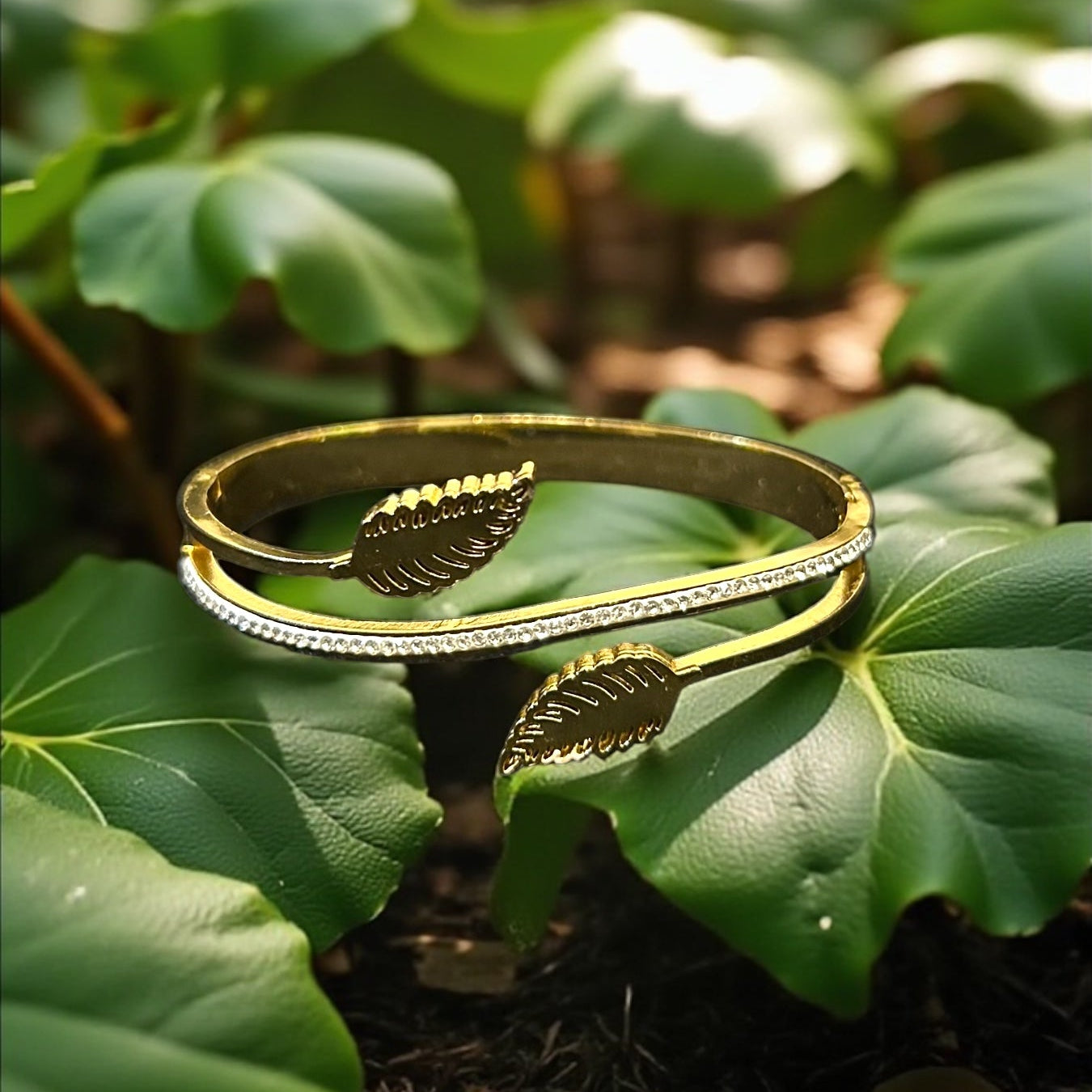 Anti tarnish Gold colour bracelet with leaf design on a bed of green leaves