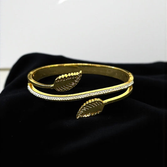 Anti tarnish Gold colour bracelet with leaf designs on a black surface