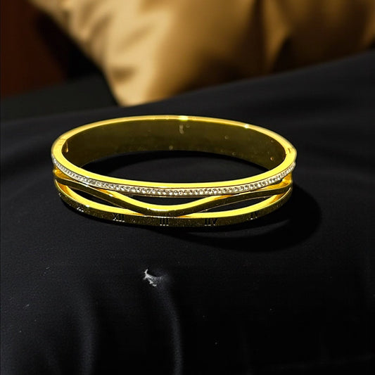 anti tarnish gold colour bracelet with rhinestones on a dark surface