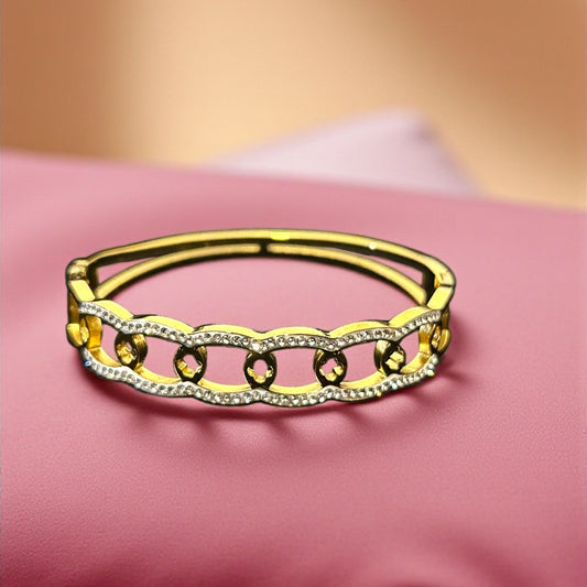 Gold ring with yellow gemstones on a pink pillow