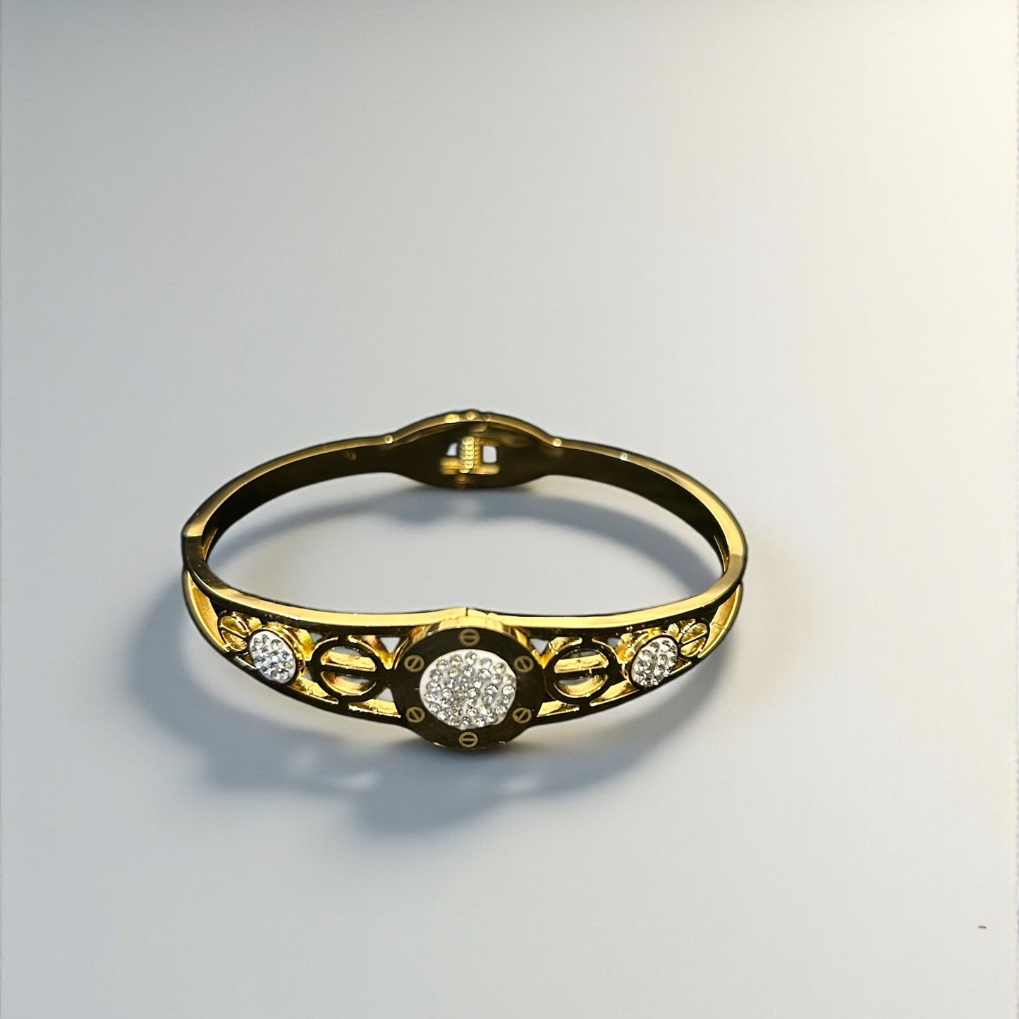 anti tarnish Gold colour bracelet with diamond accents on a light gray background