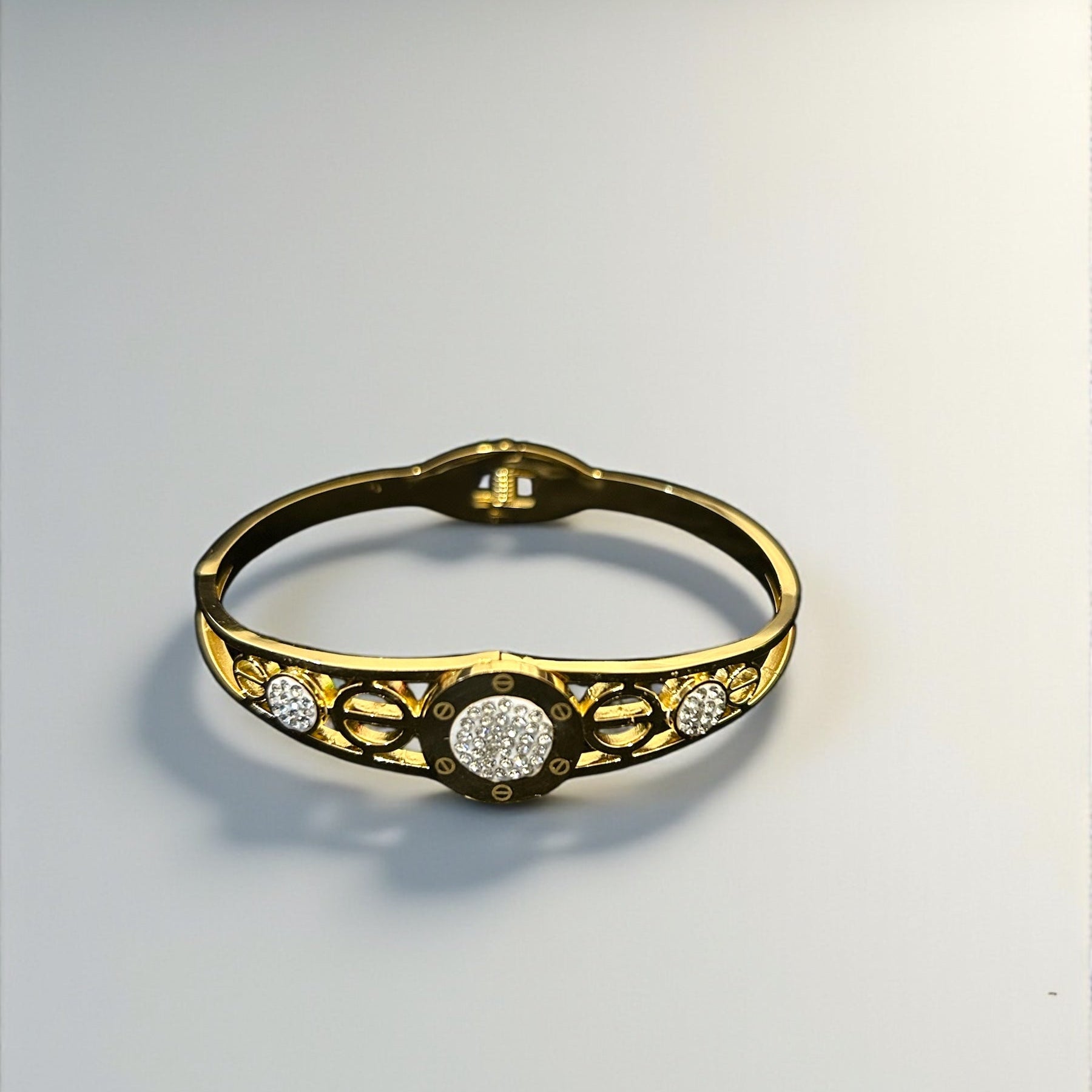 anti tarnish Gold colour bracelet with diamond accents on a light gray background