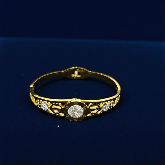 anti tarnish Gold colour bracelet with diamond accents on a dark blue background